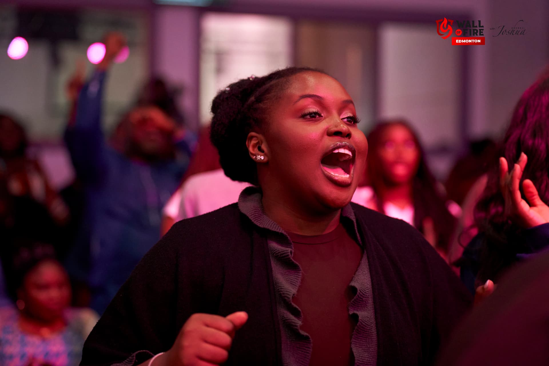 A woman singing passionately in worship
