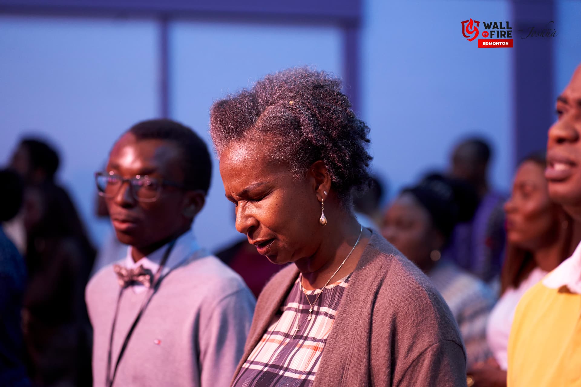 A woman praying with eyes closed